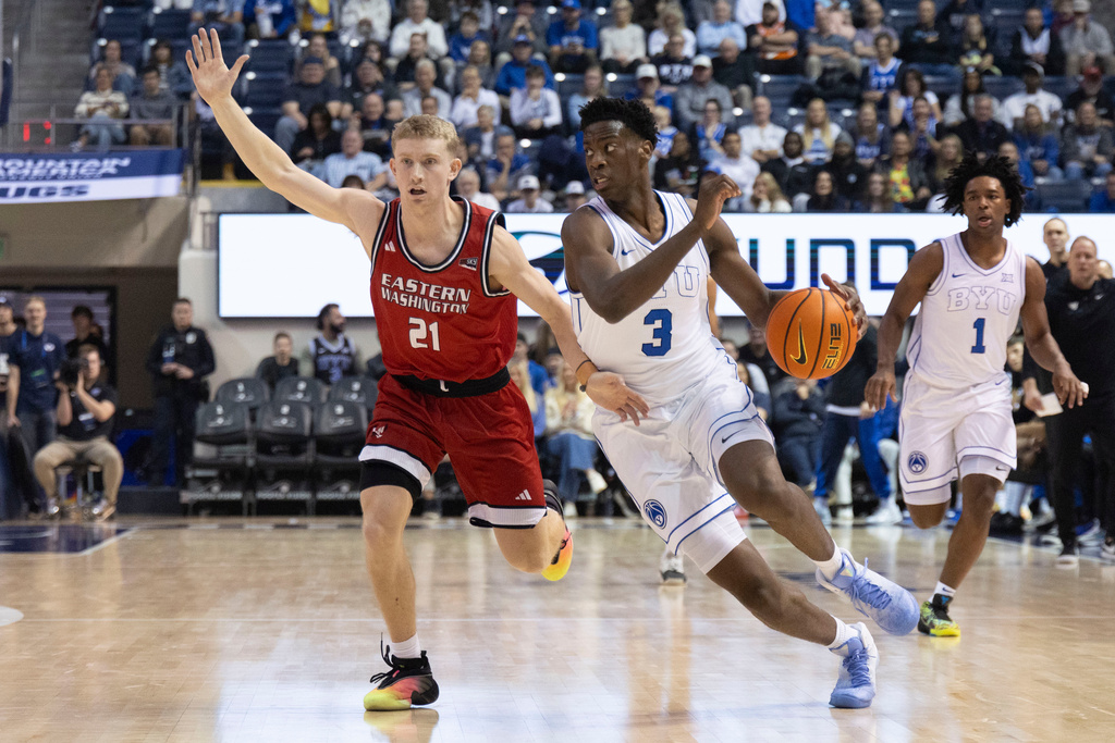 BYU forward AJ Dybantsa (3) drives to the basket against Eastern Washington guard Johnny Radford (21) during the first half of an NCAA basketball game, Monday, Dec. 22, 2025, in Provo, Utah. (AP Photo/Rob Gray)