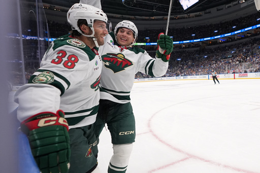 Minnesota Wild's Ryan Hartman (38) is congratulated by teammate Brock Faber after scoring during the first period of an NHL hockey game against the St. Louis Blues Thursday, Oct. 9, 2025, in St. Louis. (AP Photo/Jeff Roberson) Minnesota Wild's Ryan Hartman (38) is congratulated by teammate Brock Faber after scoring during the first period of an NHL hockey game against the St. Louis Blues Thursday, Oct. 9, 2025, in St. Louis. (AP Photo/Jeff Roberson)
