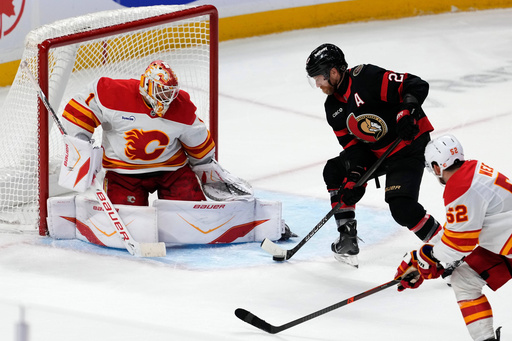 Ottawa Senators' Claude Giroux, top right, is unable to score against Calgary Flames goaltender Devin Cooley (1) during overtime NHL hockey game action in Ottawa, Ontario, Thursday, Oct. 30, 2025. (Justin Tang/The Canadian Press via AP) Ottawa Senators' Claude Giroux, top right, is unable to score against Calgary Flames goaltender Devin Cooley (1) during overtime NHL hockey game action in Ottawa, Ontario, Thursday, Oct. 30, 2025. (Justin Tang/The Canadian Press via AP)