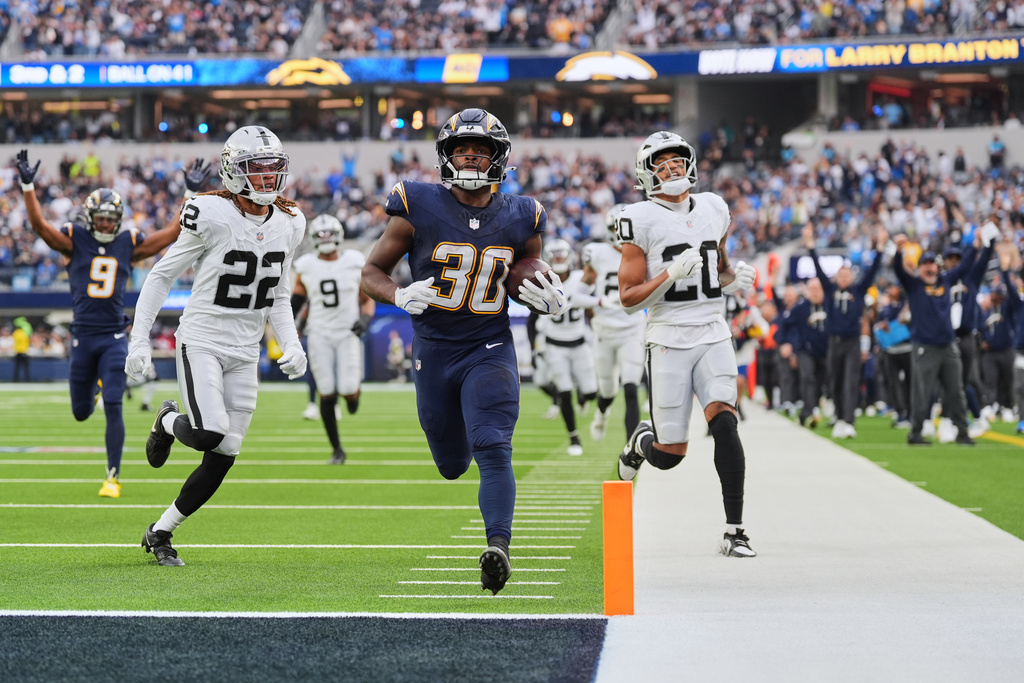 Los Angeles Chargers running back Kimani Vidal (30) scores a touchdown against the Las Vegas Raiders during the second half of an NFL football game, Sunday, Nov. 30, 2025, in Inglewood, Calif. (AP Photo/Jae C. Hong)