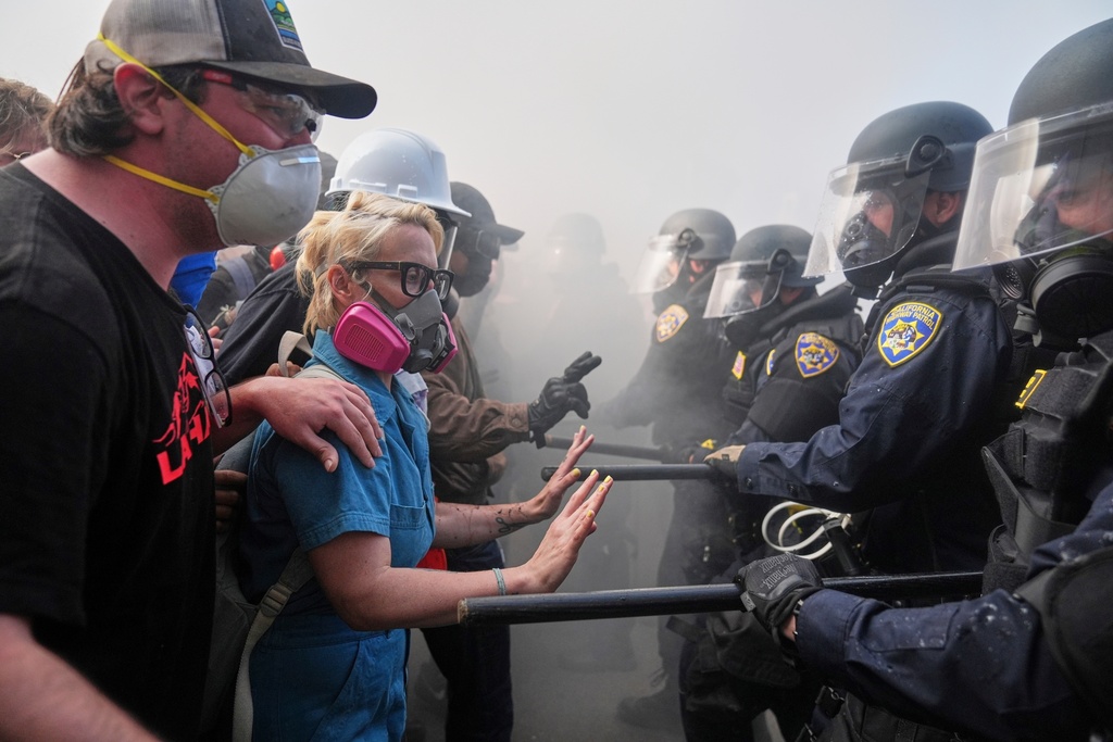 Protesters confront police on the 101 Freeway near the Metropolitan Detention Center of downtown Los Angeles, June 8, 2025, following an immigration raid protest the night before. (AP Photo/Jae C. Hong, File)