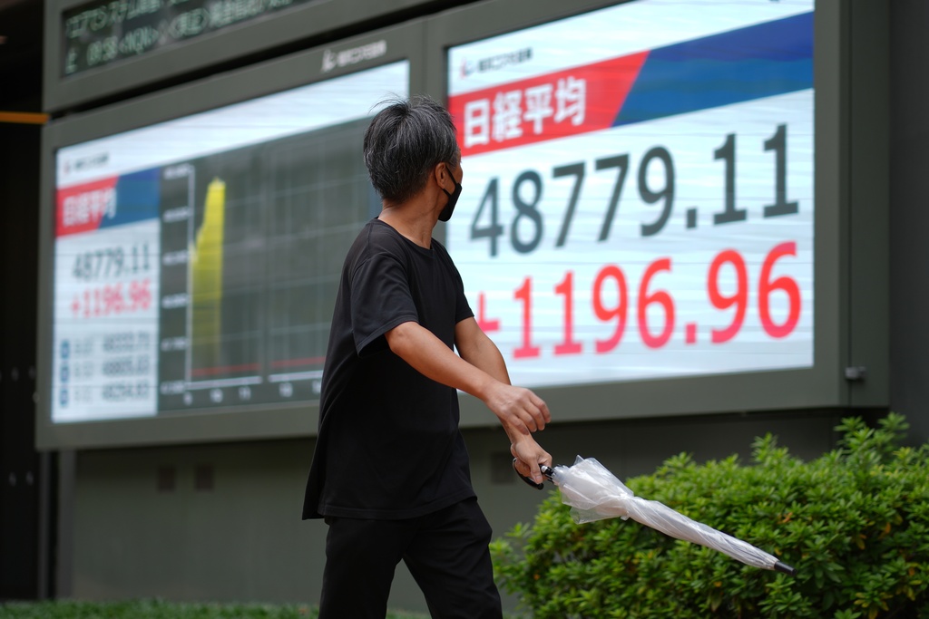 A person looks at an electronic stock board showing Japan's Nikkei index at a securities firm Monday, Oct. 20, 2025, in Tokyo. (AP Photo/Eugene Hoshiko)
