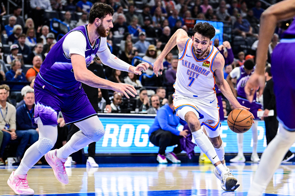 Oklahoma City Thunder center/forward Chet Holmgren (7) drives against Utah Jazz center Jusuf Nurkić (30) during the first half of an NBA basketball game, Wednesday, Jan. 7, 2025, in Oklahoma City. (AP Photo/Gerald Leong)
