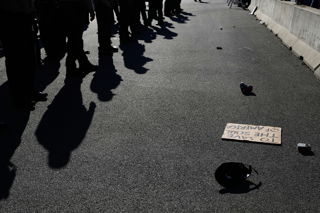Illinois State Police and Cook County Sheriff Police guard as protesters gather outside an ICE processing facility in the Chicago suburb of Broadview, Ill., Friday, Nov. 14, 2025. (AP Photo/Nam Y. Huh)