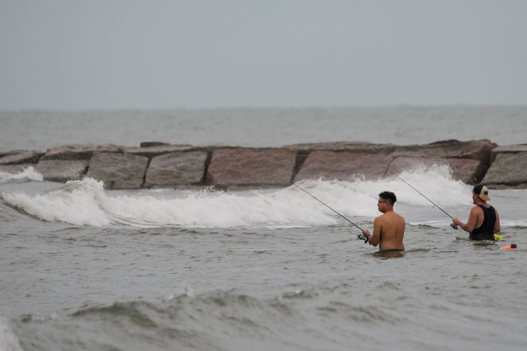 Fishermen cast their lines in surf stirred up by Tropical Storm Edouard in Galveston, Texas, Tuesday, Sept. 1, 2026. (Brett Coomer/Houston Chronicle via AP)