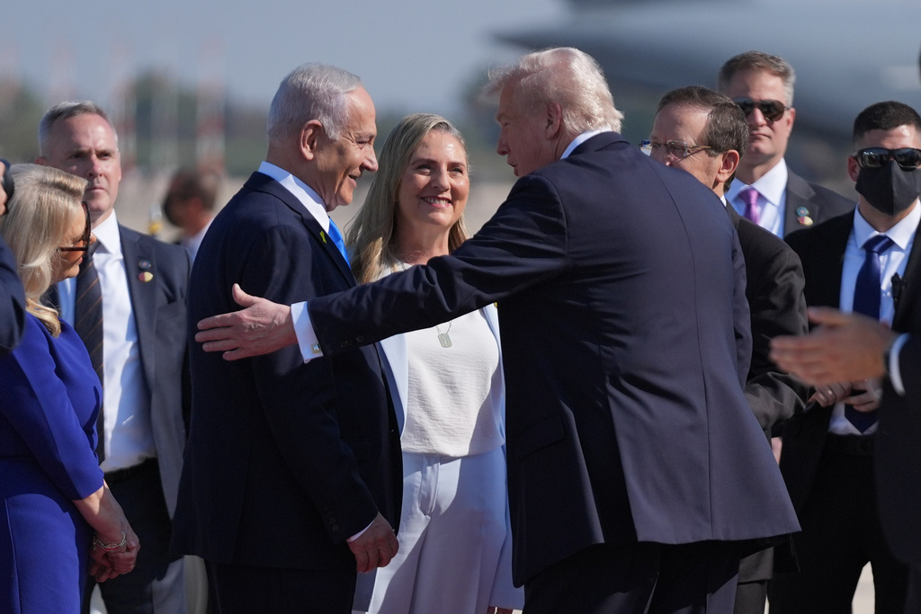 President Donald Trump greets Israel's Prime Minister Benjamin Netanyahu as he arrives at Ben Gurion International Airport, Monday, Oct. 13, 2025, near Tel Aviv. (AP Photo/Evan Vucci)