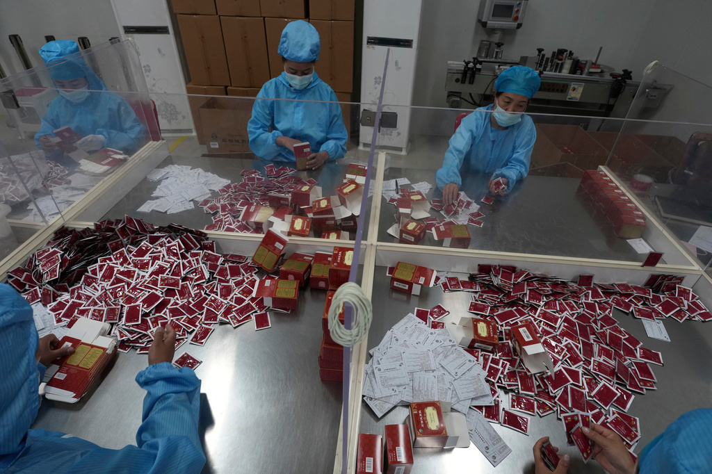 Workers pack traditional Tibetan medicine produced by the Xizang Gansu Tibetan Medicine Co. Ltd in Lhasa, in western China's Tibet Autonomous Region on Wednesday, July 22, 2026 as seen during a government organized visit for foreign journalists. (AP Photo/Ng Han Guan)