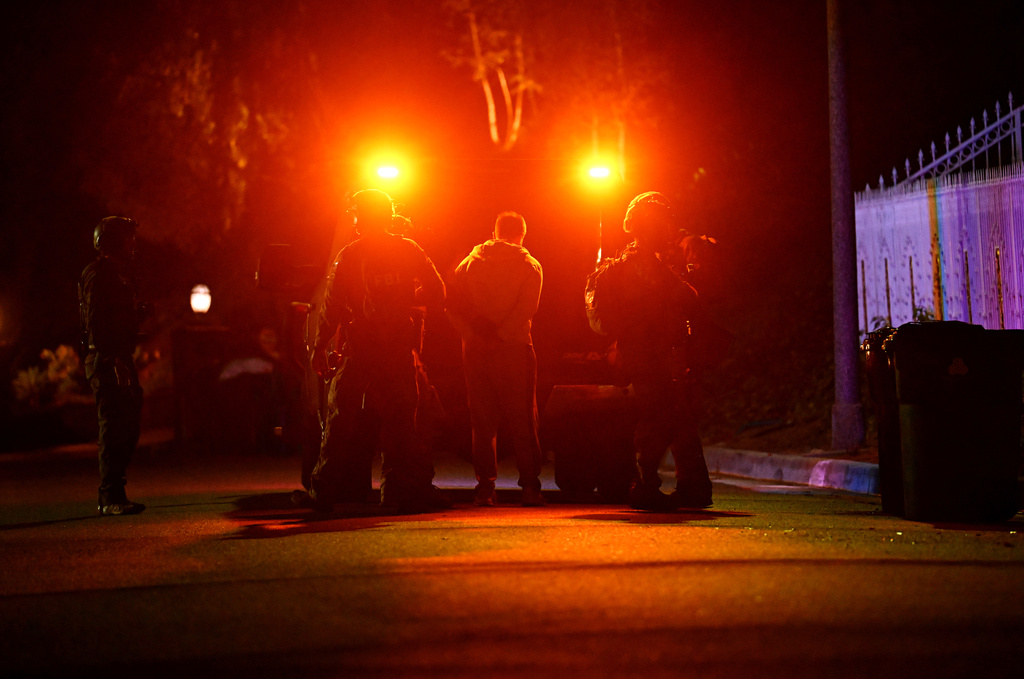 Federal agents arrest a suspect during a raid related to health care fraud in the early morning on Thursday, Oct. 22, 2026, in Los Angeles. (AP Photo/Wally Skalij)