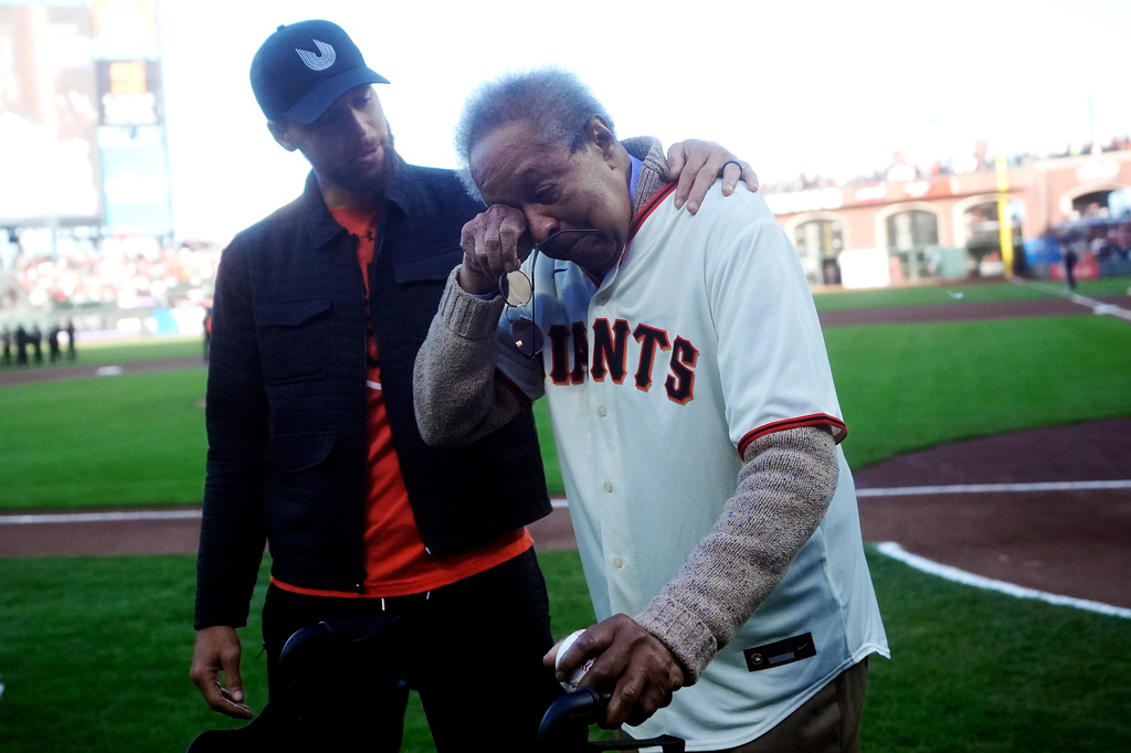 FILE - Dr. Clarence B. Jones, right, a former speech writer for Martin Luther King Jr., wipes his eyes next to Golden State Warriors basketball player Stephen Curry after Jones threw out the ceremonial first pitch before a baseball game between the San Francisco Giants and the New York Yankees in San Francisco, May 31, 2024. (AP Photo/Jeff Chiu, File)