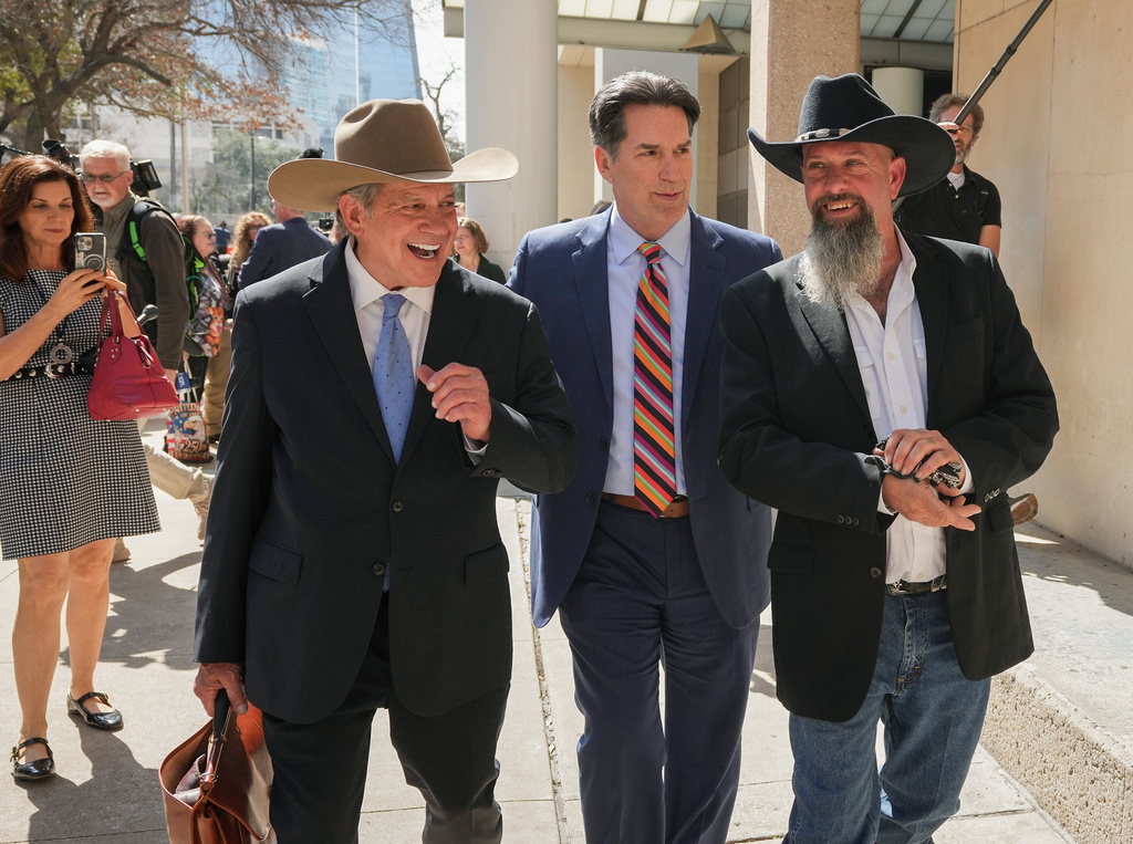 Forrest Welborn, right, leaves the courthouse with his attorney Steve Goodson, left, after being after being exonerated at a hearing for four men wrongfully accused in the 1991 Austin yogurt shop murders, at the Blackwell-Thurman Criminal Justice Center in Austin, Texas, Thursday, Feb. 19, 2026. (Jay Janner/Austin American-Statesman via AP)