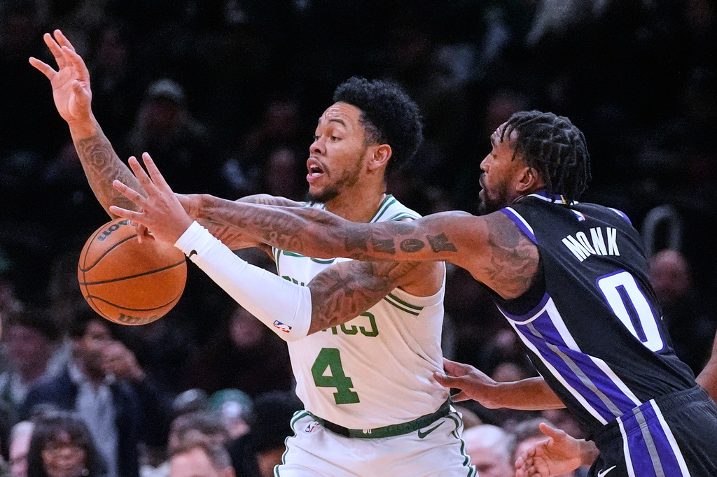 Sacramento Kings guard Malik Monk (0) knocks the ball from the hands of Boston Celtics guard Anfernee Simons (4) during the second half of an NBA basketball game, Friday, Jan. 30, 2026, in Boston. (AP Photo/Charles Krupa)