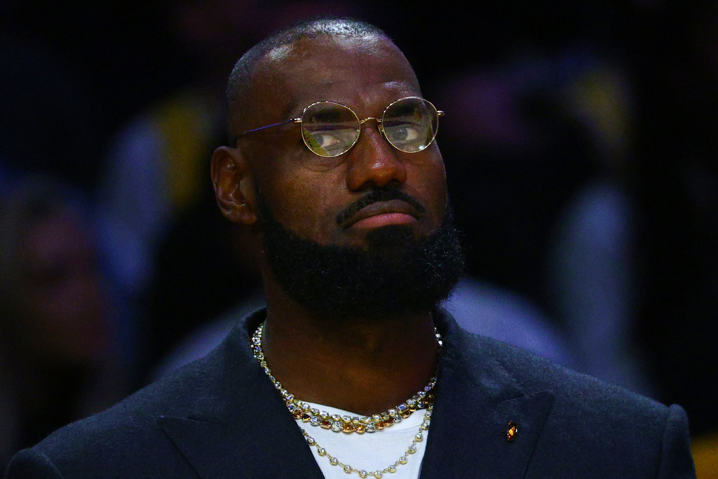 Los Angeles Lakers forward Lebron James sits on the bench during the first half of an NBA basketball game against the Golden State Warriors, Tuesday, Oct. 21, 2025, in Los Angeles. (AP Photo/Ethan Swope)