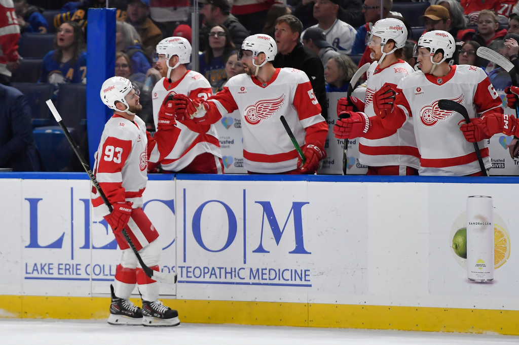 Detroit Red Wings right wing Alex DeBrincat (93) celebrates with teammates after scoring during the first period of an NHL hockey game against the Buffalo Sabres, Friday, March 27, 2026, in Buffalo, N.Y. (AP Photo/Adrian Kraus)