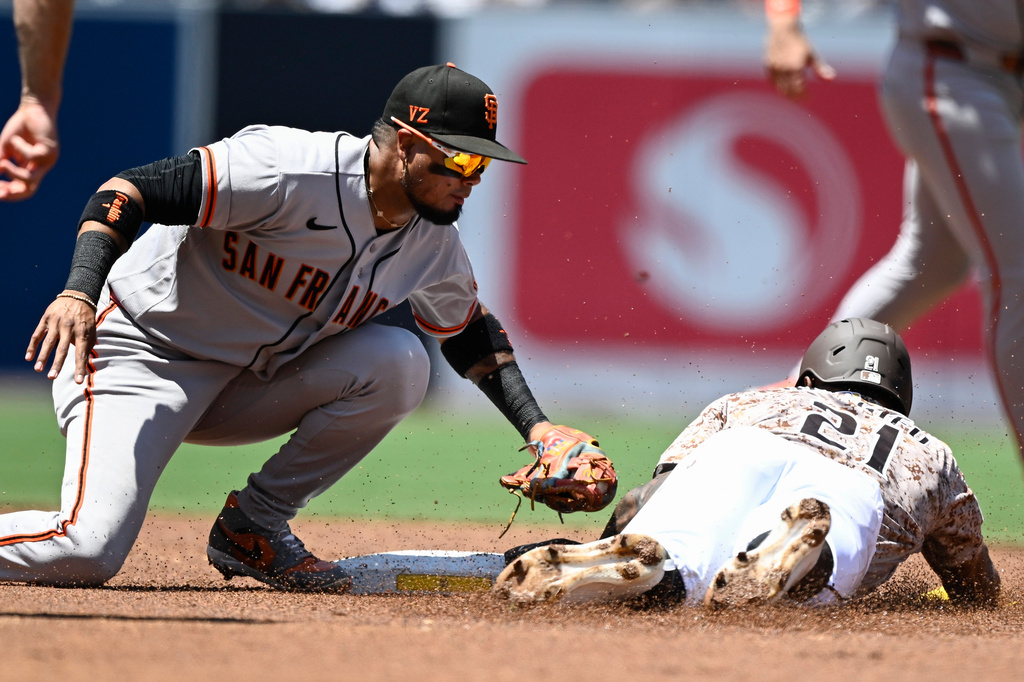 San Diego Padres' Luis Rengifo (21) is tagged out by San Francisco Giants second baseman Luis Arraez, left, as he tries to steal second during the first inning of a baseball game Sunday, Aug. 2, 2026, in San Diego. (AP Photo/Denis Poroy)