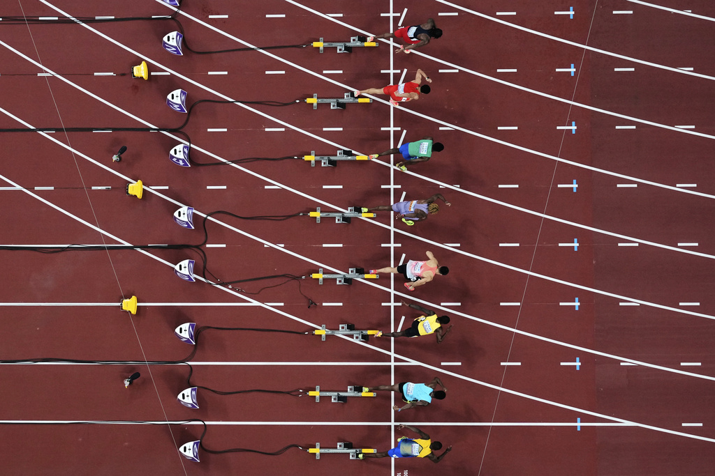 Athletes compete during the men's 100 meters heat 3 at the World Athletics Championships in Tokyo, Saturday, Sept. 13, 2025. (AP Photo/Bernat Armangue)