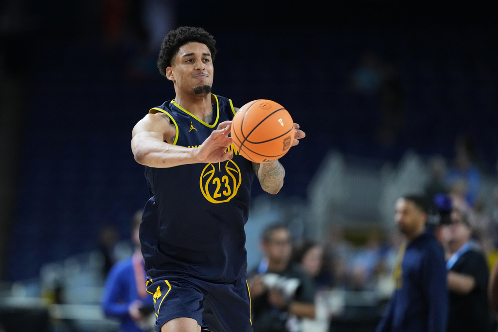 Michigan's Yaxel Lendeborg passes during practice ahead of an NCAA college basketball tournament semifinal game against Arizona at the Final Four, Friday, April 3, 2026, in Indianapolis. (AP Photo/Michael Conroy)