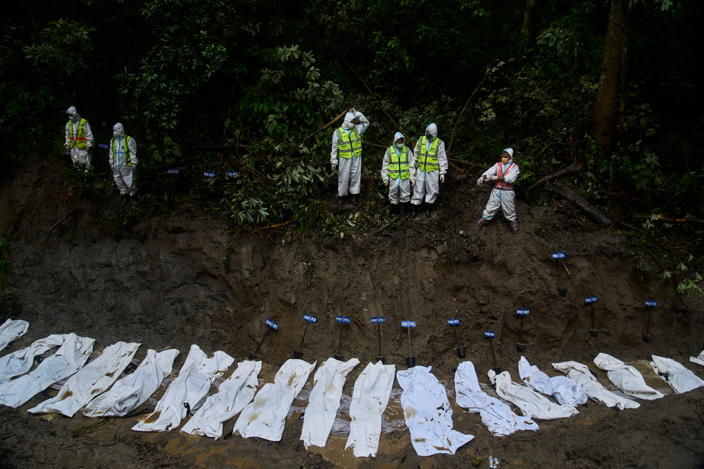 Nepal police personnel prepare the bodies of flash flood victims for a mass burial in Kathmandu, Nepal, Tuesday, Sept. 1, 2026. (AP Photo/Niranjan Shrestha)