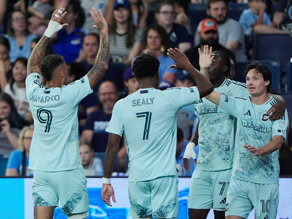 Colorado Rapids midfielder Paxten Aaronson, right, celebrates with teammates after scoring a goal during the first half of an MLS soccer match against Sporting Kansas City, Saturday, March 21, 2026, in Kansas City, Kan. (AP Photo/Charlie Riedel)