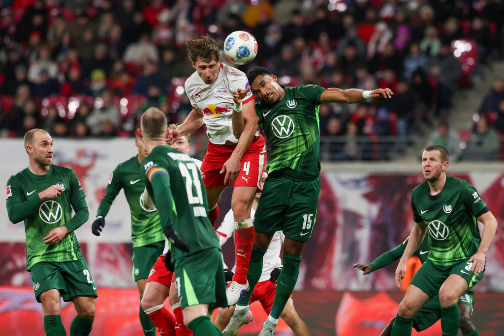 Leipzig's Willi Orban, top left, and Wolfsburg's Moritz Jenz in action during the Bundesliga soccer match between RB Leipzig and VfL Wolfsburg in Leipzig, Germany, Sunday Feb. 15, 2026. (Jan Woitas/dpa via AP)