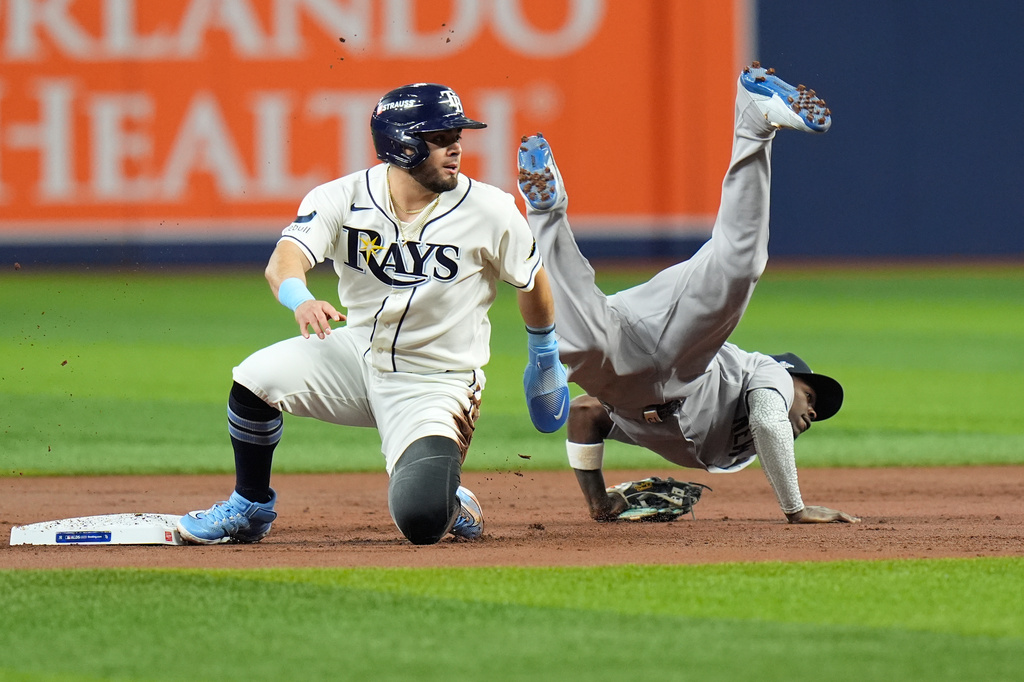 New York Yankees second baseman Jazz Chisholm Jr., right, flips over Tampa Bay Rays' Jonathan Aranda, left, while committing a throwing error allowing Rays' Yandy D&iacute;az to score during the first inning in Game 2 of an American League Division Series baseball game Monday, Oct. 5, 2026, in St. Petersburg, Fla. (AP Photo/Chris O'Meara)