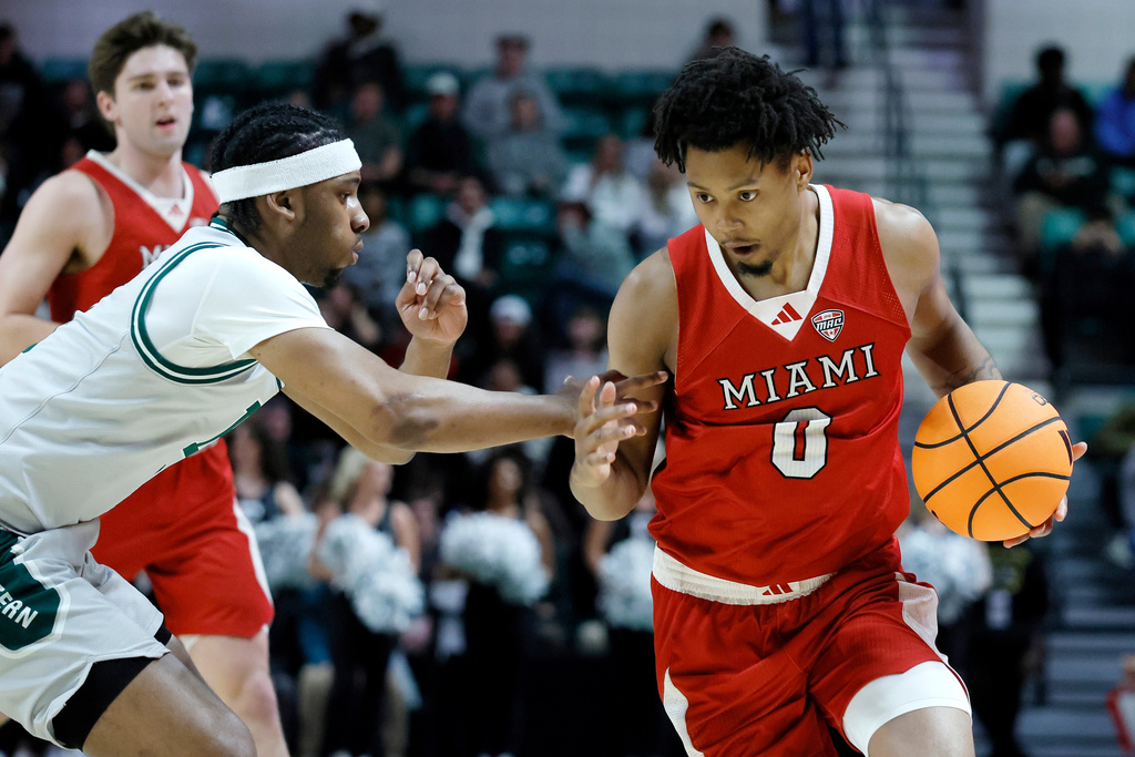 Miami (OH) forward Eian Elmer (0) drives to the basket against Eastern Michigan guard Gregory Lawson, left, during the first half of an NCAA college basketball game Tuesday, Feb. 24, 2026, in Ypsilanti, Mich. (AP Photo/Duane Burleson)