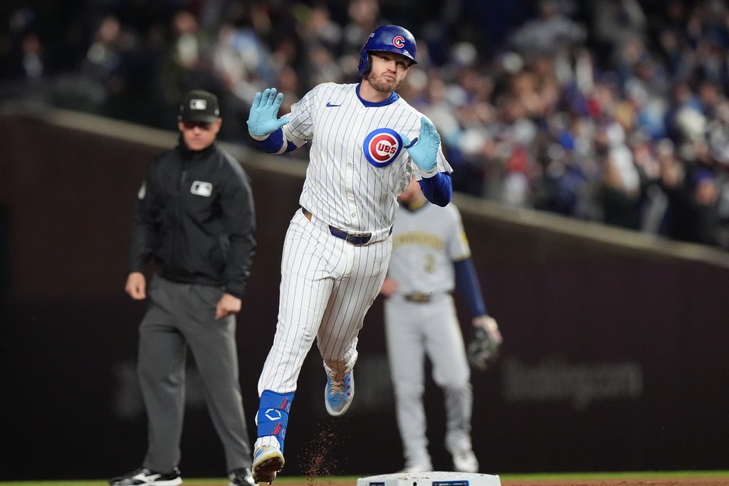 Chicago Cubs' Ian Happ (8) runs the bases after hitting a 3-run home run during the first inning of Game 4 of baseball's National League Division Series against the Milwaukee Brewers Thursday, Oct. 9, 2025, in Chicago. (AP Photo/Nam Y. Huh)