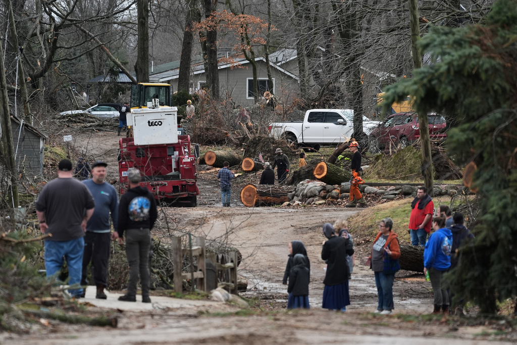 Volunteers work to clear up debris in the aftermath of a powerful storm that ripped through the area a day earlier, in Union City Mich., Saturday, March 7, 2026. (AP Photo/Nam Y. Huh)
