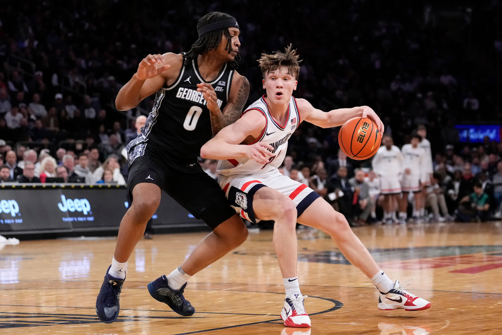 UConn guard Braylon Mullins, right, drives past Georgetown forward Jayden Fort (0) during the first half of an NCAA college basketball game in the semifinals of the Big East tournament, Friday, March 13, 2026, in New York. (AP Photo/Yuki Iwamura)