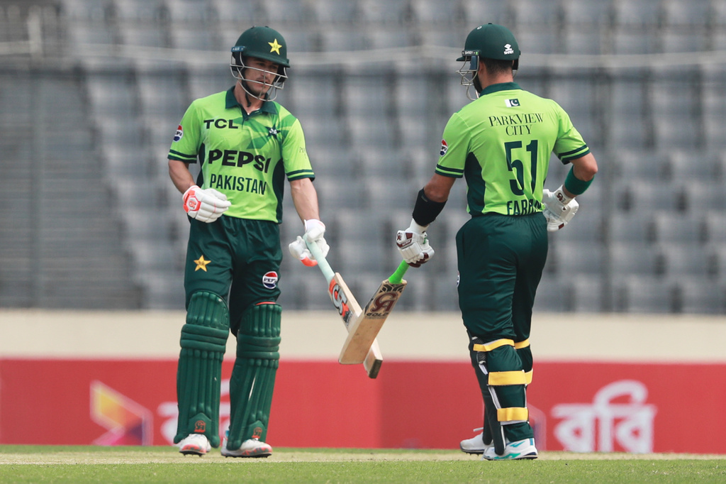 Pakistan's Sahibzada Farhan and batting partner Maaz Sadaqat touch bats after hitting a boundary during the first one day international cricket match between Bangladesh and Pakistan in Mirpur, Bangladesh, Wednesday, March 11, 2026. (AP Photo/Mahmud Hossain Opu)