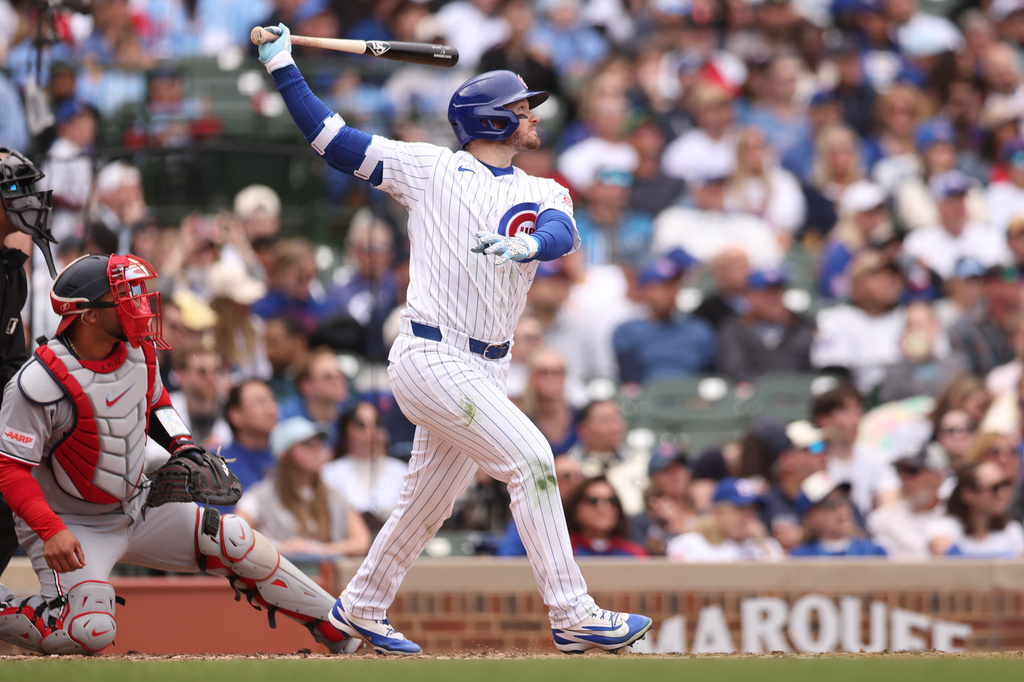 Chicago Cubs Ian Happ (8) hits a solo home run during the fourth inning of a baseball game against the Washington Nationals at Wrigley Field on Sunday, March 29, 2026, in Chicago. (AP Photo/Geoff Stellfox)