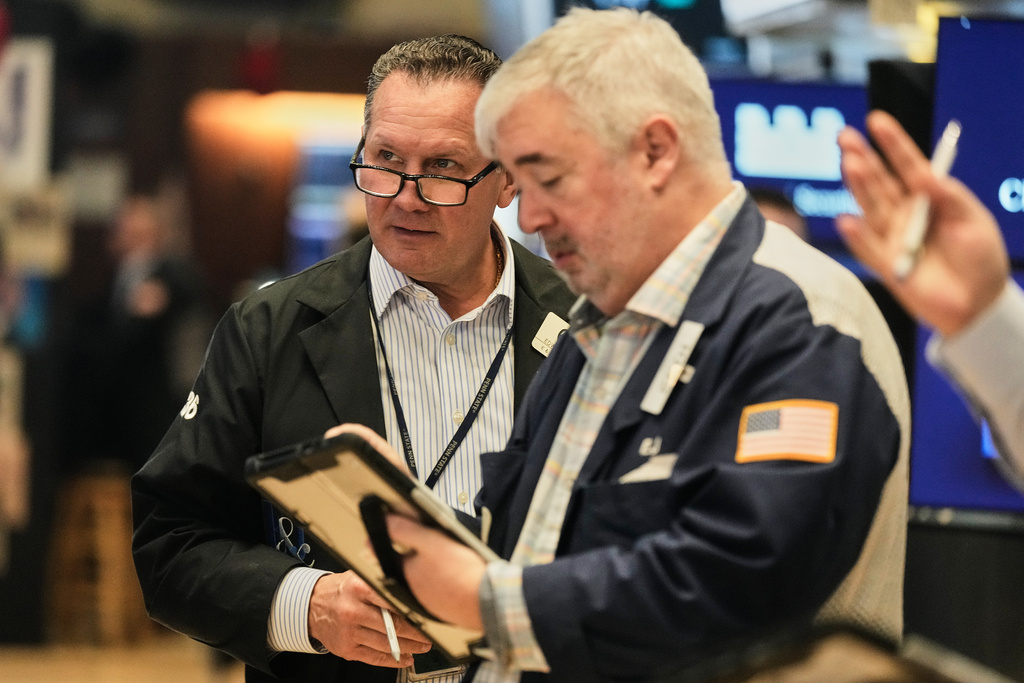 Traders Edward Curran, left, and Edward McCarthy work on the floor of the New York Stock Exchange, Wednesday, Oct. 15, 2025. (AP Photo/Richard Drew)