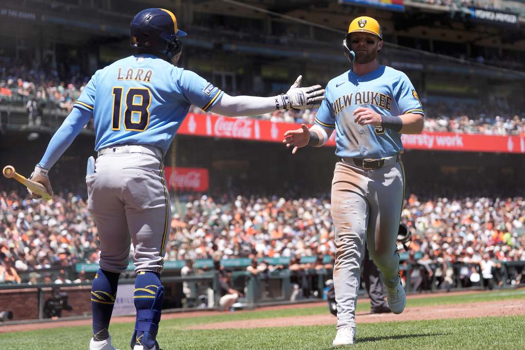 Milwaukee Brewers' Jake Bauers, right, is congratulated by Luis Lara (18) after scoring against the San Francisco Giants during the fourth inning of a baseball game, Wednesday, July 29, 2026, in San Francisco. (AP Photo/Jeff Chiu)
