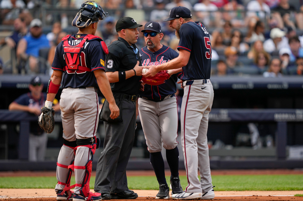Atlanta Braves pitcher Chris Sale, right, argues with home plate umpire Dan Merzel, second left, during the fifth inning of a baseball game against the New York Yankees, Saturday, Aug. 8, 2026, in New York. (AP Photo/Yuki Iwamura)
