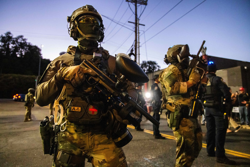 Federal enforcement officers stand guard near a U.S. Immigration and Customs Enforcement facility in Portland, Ore., Monday, Oct. 6, 2025. (AP Photo/Ethan Swope) Federal enforcement officers stand guard near a U.S. Immigration and Customs Enforcement facility in Portland, Ore., Monday, Oct. 6, 2025. (AP Photo/Ethan Swope)