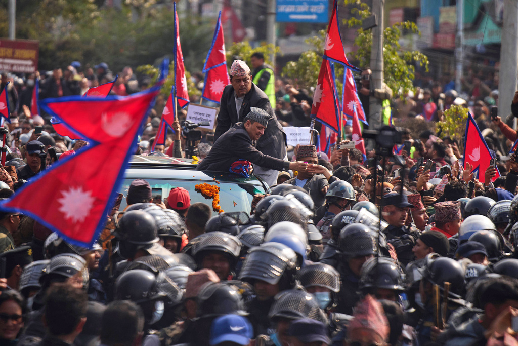 Former King Gyanendra Shah receives flowers from supporters upon his arrival at Tribhuvan International Airport in Kathmandu, Nepal, Friday, Feb. 13, 2026. (AP Photo/Niranjan Shrestha)
