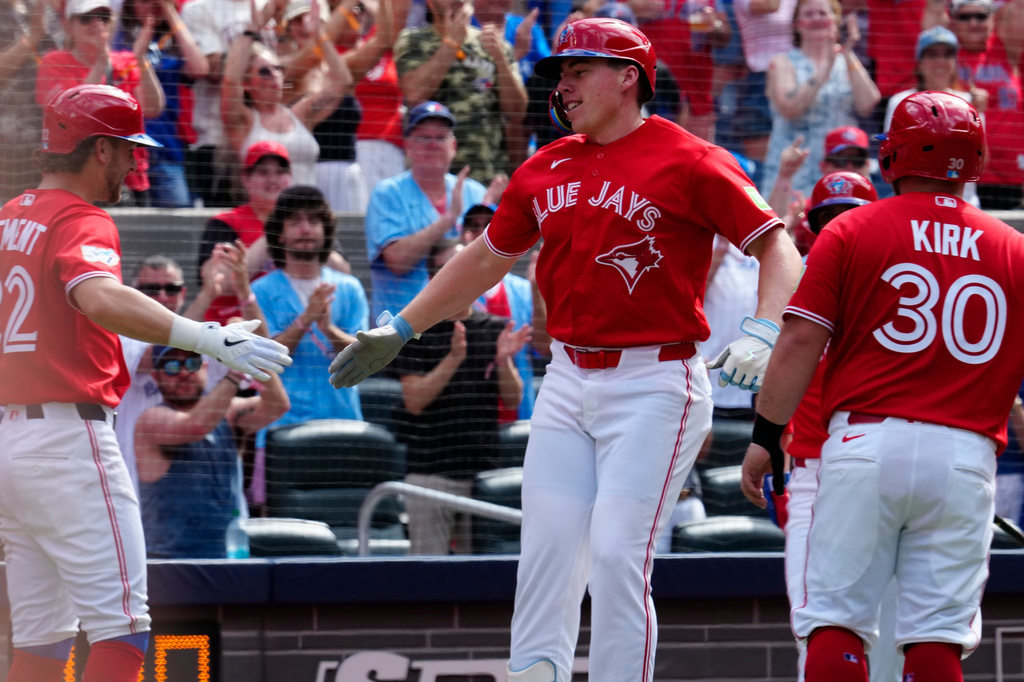 Toronto Blue Jays' Ernie Clement, left, and Alejandro Kirk congratulates Sean Keys after he hit a three run home run against the New York Mets during third inning MLB baseball action in Toronto on Wednesday, July 1, 2026. (Frank Gunn/The Canadian Press via AP)