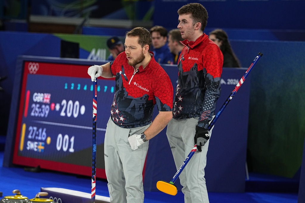 United States' Luc Violette and Daniel Casper look on, during the men's curling round robin session against Switzerland at the 2026 Winter Olympics, in Cortina d'Ampezzo, Italy, Thursday, Feb. 12, 2026. (AP Photo/Fatima Shbair)
