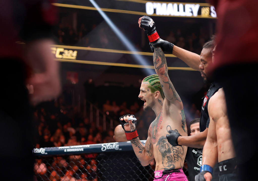 Sean O'Malley, left, is declared the winner over Song Yadong in a bantamweight bout during the UFC 324 mixed martial arts event Saturday Jan. 24, 2026, in Las Vegas. (AP Photo/Steve Marcus)