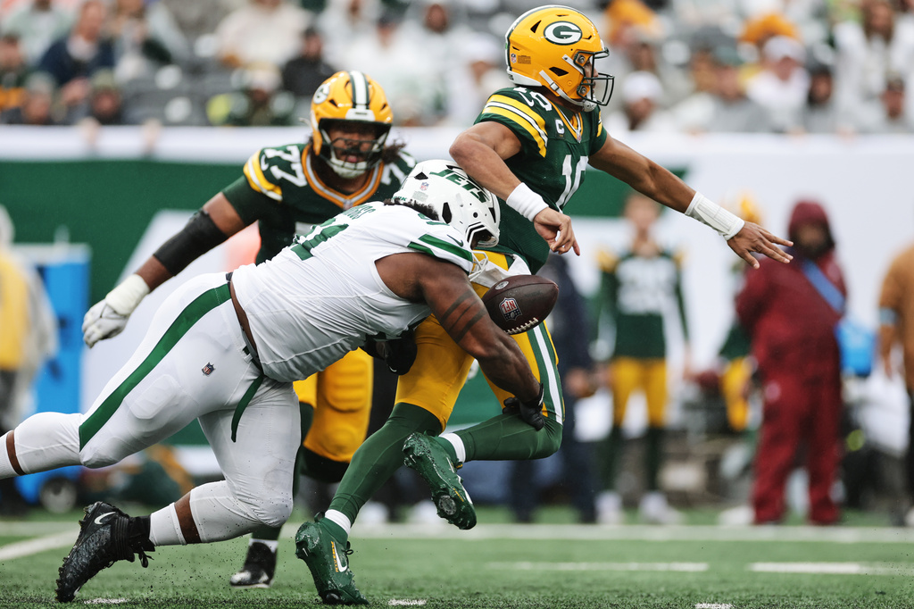 Green Bay Packers quarterback Jordan Love (10) is tackled by New York Jets defensive end Jowon Briggs (91) during an NFL football game in East Rutherford, N.J., Sunday, Sept. 20, 2026. (AP Photo/Adam Hunger)