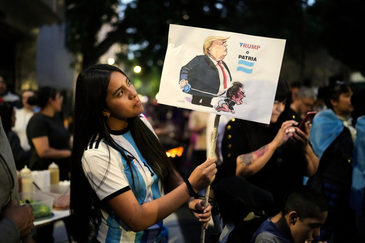 A woman holds a banner reading in Spanish, "Trump or homeland," outside former President Cristina Fernandez's home, where she is serving a six-year house arrest sentence for corruption, after polls closed during legislative midterm elections in Buenos Aires, Argentina, Sunday, Oct. 26, 2025. (AP Photo/Natacha Pisarenko) A woman holds a banner reading in Spanish, "Trump or homeland," outside former President Cristina Fernandez's home, where she is serving a six-year house arrest sentence for corruption, after polls closed during legislative midterm elections in Buenos Aires, Argentina, Sunday, Oct. 26, 2025. (AP Photo/Natacha Pisarenko)