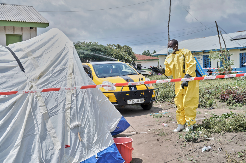 A man sprays a tent at an Ebola treatment center in Bunia, Congo, Tuesday, May 19, 2026. (AP Photo/Dirole Lotsima Dieudonne)