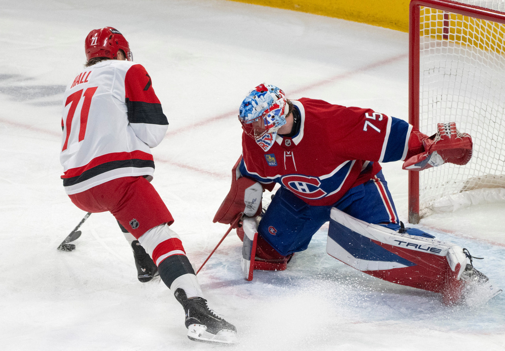 Montreal Canadiens goaltender Jakub Dobes (75) stops Carolina Hurricanes' Taylor Hall (71) on a breakaway during the first period of an NHL hockey game in Montreal on Tuesday, March 24, 2026. (Christinne Muschi/The Canadian Press via AP)