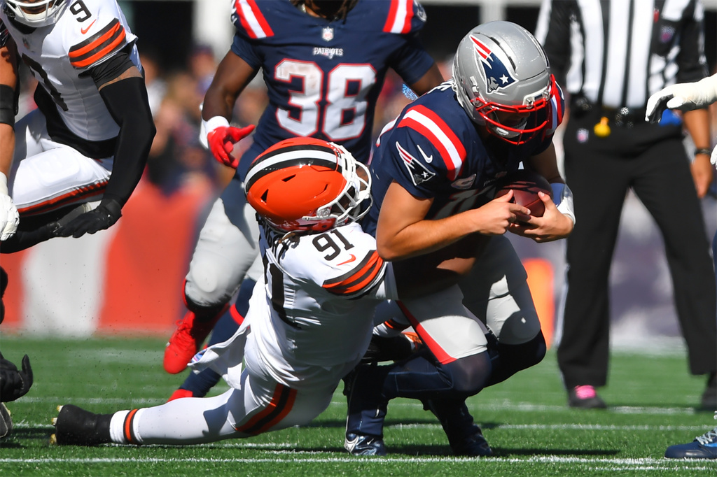 New England Patriots quarterback Drake Maye (10) is sacked by Cleveland Browns defensive end Alex Wright (91) in the first half of an NFL football game on Sunday, Oct. 26, 2025, in Foxborough, Mass. (AP Photo/Steven Senne)