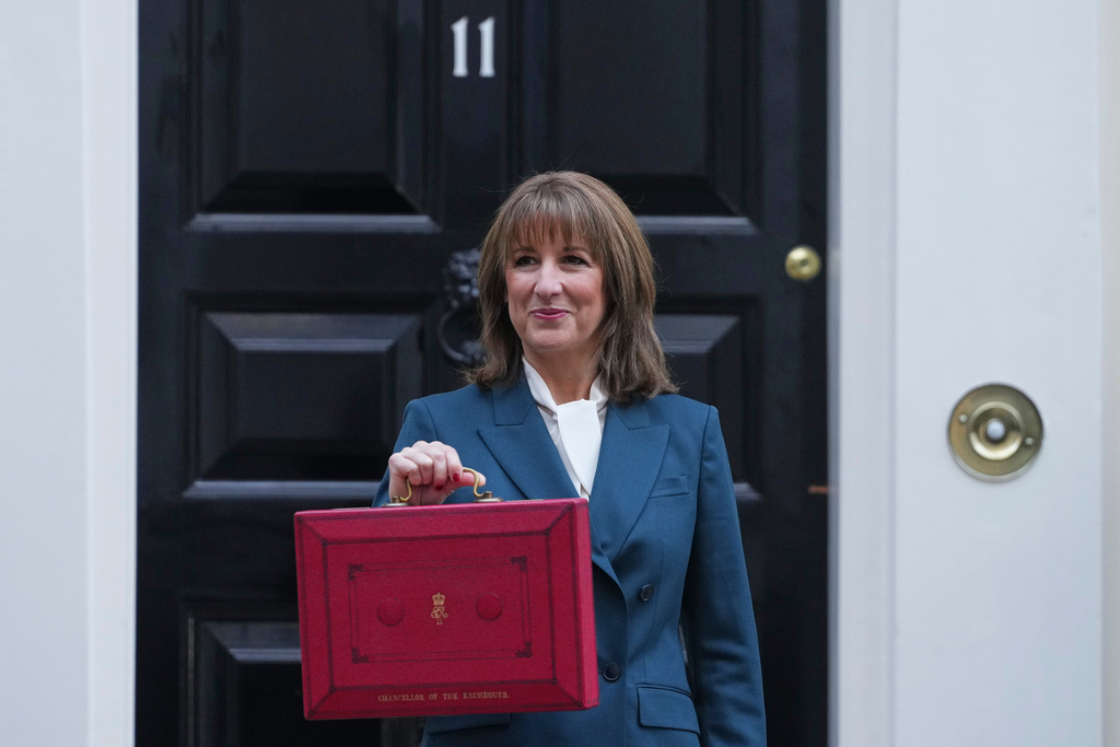 Britain's Chancellor of the Exchequer Rachel Reeves poses on the doorstep of 11 Downing Street with her ministerial red box before heading to the House of Commons to deliver her Budget speech in London, Wednesday, Nov. 26, 2025. (AP Photo/Kirsty Wigglesworth)