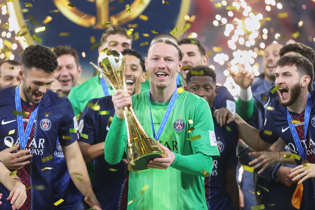 PSG's goalkeeper Matvey Safonov holds the trophy after winning the FIFA Intercontinental Cup final soccer match between Flamengo and Paris Saint-Germain in Doha, Qatar, Wednesday, Dec. 17, 2025. (AP Photo/Hussein Sayed)