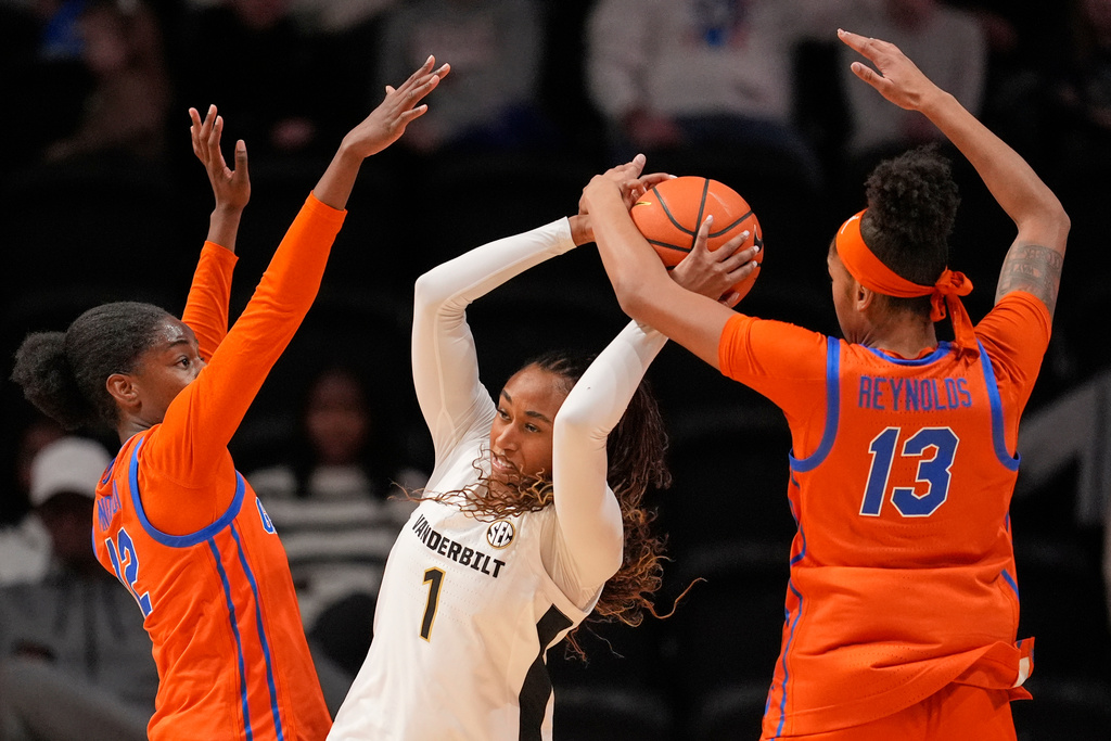 Vanderbilt guard Mikayla Blakes (1) loses the ball as she is defended by Florida guards Daviane Mindoudi (12) and Laila Reynolds (13) during the first half of an NCAA college basketball game Sunday, Feb. 1, 2026, in Nashville, Tenn. (AP Photo/George Walker IV)