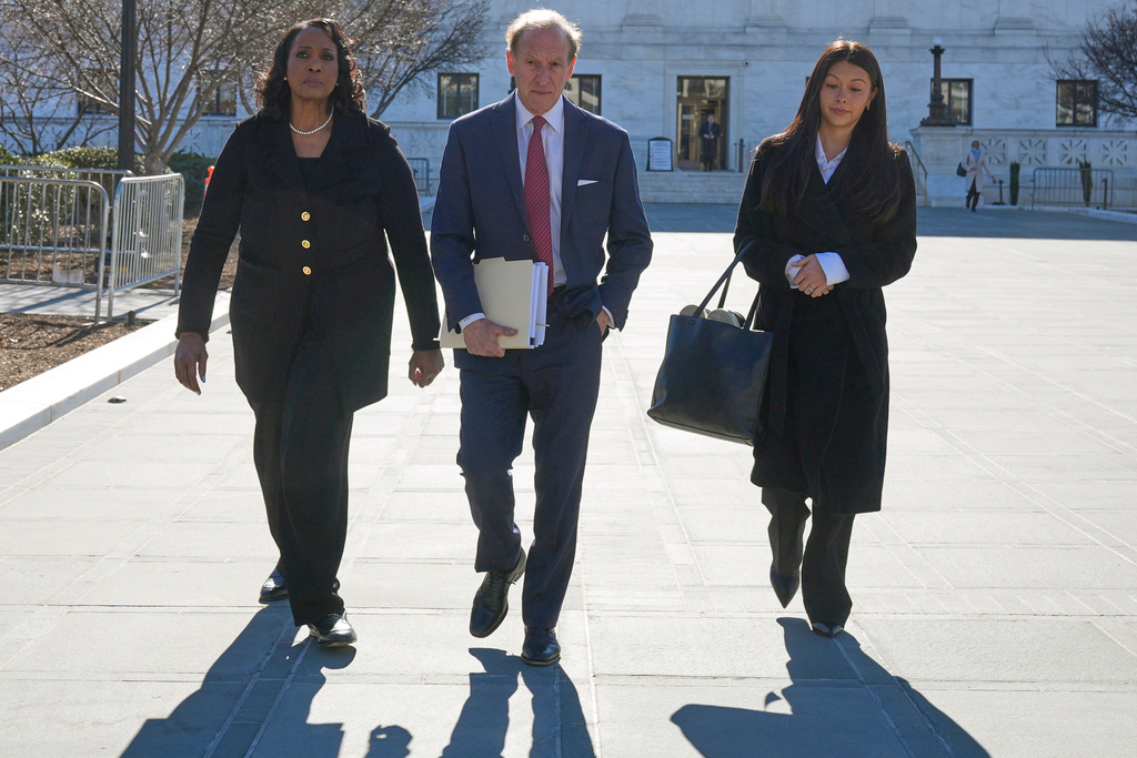 Federal Reserve governor Lisa Cook, left, and her attorneys leave the Supreme Court in Washington, Wednesday, Jan. 21, 2026. (AP Photo/Mark Schiefelbein)
