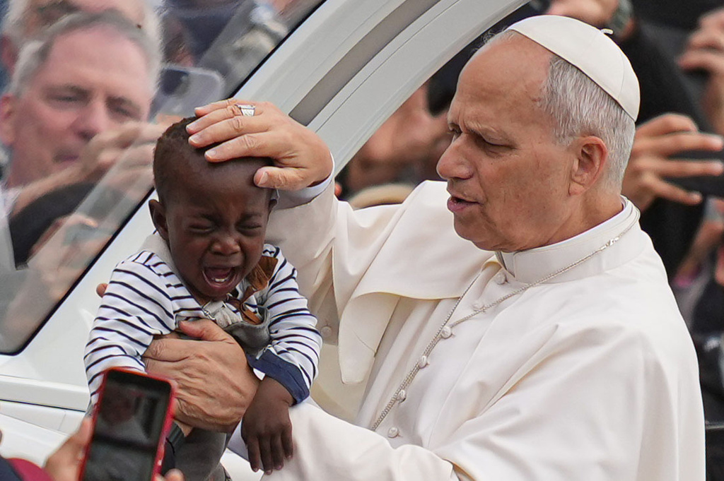 FILE - Pope Leo XIV blesses a child at the end of a Mass for the Jubilee of Migrants and Missionaries in St. Peter's Square at the Vatican, Sunday, Oct. 5, 2025. (AP Photo/Alessandra Tarantino, File)