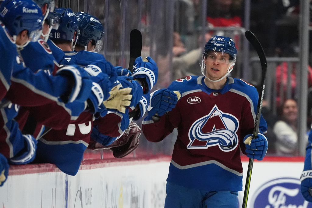 Colorado Avalanche left wing Artturi Lehkonen, right, is congratulated after scoring a goal as he passes the team box in the second period of an NHL hockey game against the San Jose Sharks Wednesday, Feb. 4, 2026, in Denver. (AP Photo/David Zalubowski)