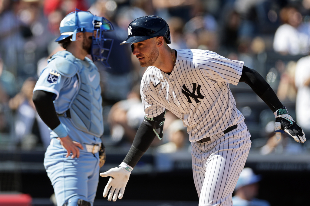 New York Yankees' Cody Bellinger reacts in front of Kansas City Royals catcher Carter Jensen after hitting a two-run home run during the sixth inning of a baseball game Saturday, April 18, 2026, in New York. (AP Photo/Adam Hunger)